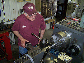 man on metal lathe